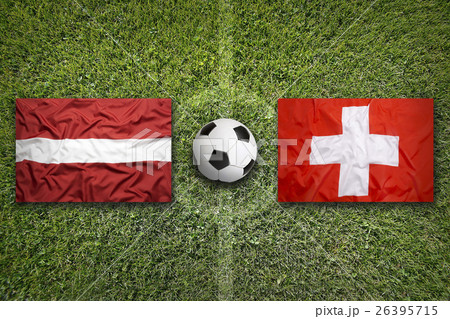Latvia vs. Switzerland flags on soccer field Latvia vs. Switzerland flags on soccer field 26395715