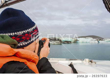Tourist man taking photo of ice blocks in Iceland Tourist man taking photo of ice blocks in Iceland 26397633