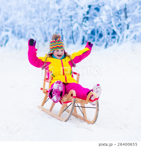 Kids play in snow. Winter sleigh ride for children Kids play in snow. Winter sleigh ride for children 26400655