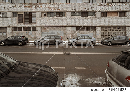 Empty lanes of city street and parked cars on both Empty lanes of city street and parked cars on both 26401623