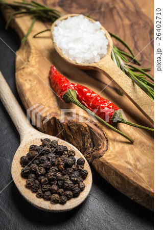 Chili with black pepper and salt on wooden table. 26402710