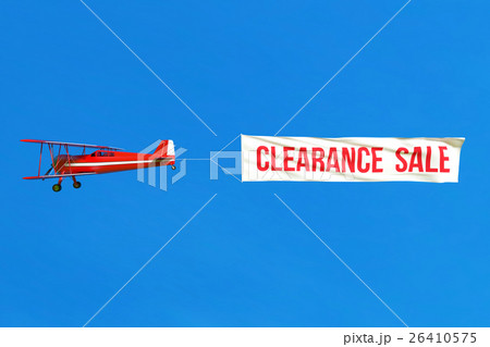 Flying airplane and Sale banner on blue sky.  26410575