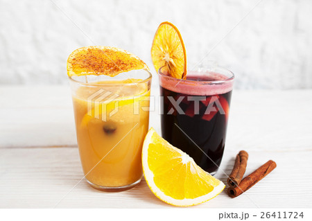 Punch and orange juice glasses on white background 26411724