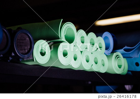 Yoga mats green and blue colors on the shelf. Yoga mats green and blue colors on the shelf. 26416178