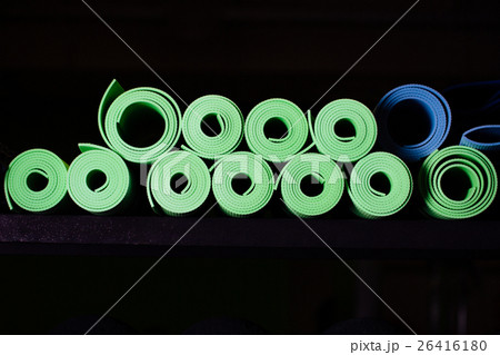Yoga mats green and blue colors on the shelf. 26416180