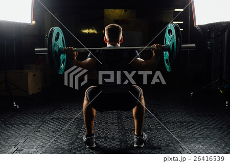 Man training squats with barbells over head. Man training squats with barbells over head. 26416539