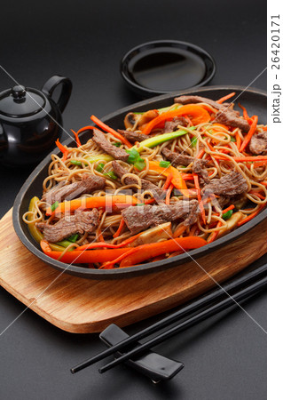 Soba noodles with veal over black background Soba noodles with veal over black background 26420171