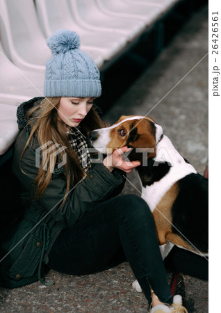 Young hipster girl with her pet estonian hound dog 26426561