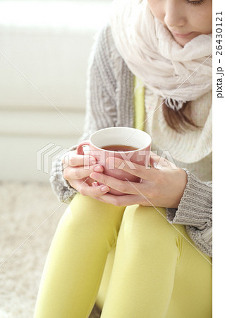 温かい飲み物を飲む女性の写真素材
