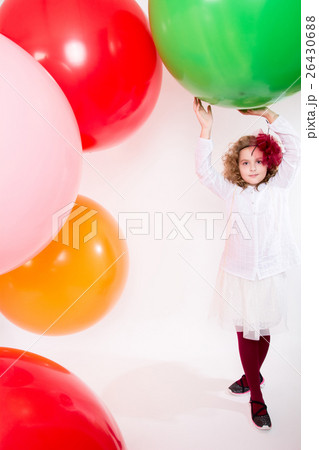Teen girl in a hat and white dress on a background of big colore 26430688