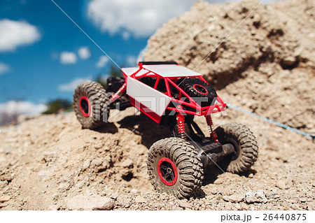 Rc car riding on rock land, close-up 26440875