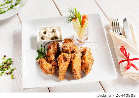 Grilled wings with vegetables and cutlery 26440985