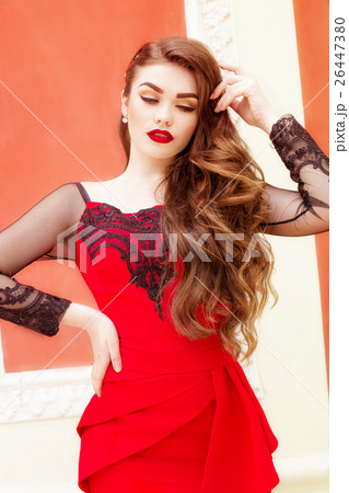 Beautiful young girl in a red evening long dress 26447380