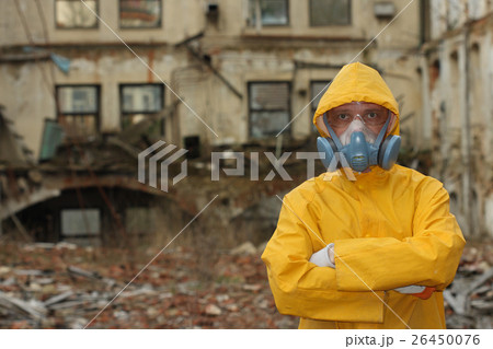 Man with protective mask explores danger area. 26450076