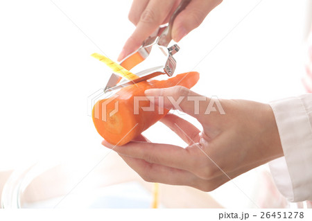 ピーラーで人参の皮をむく女性 26451278