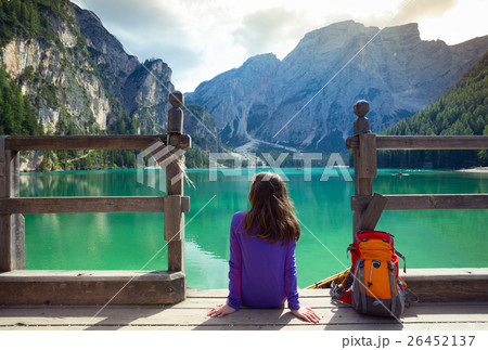 girl backpacker looking at Braies lake 26452137