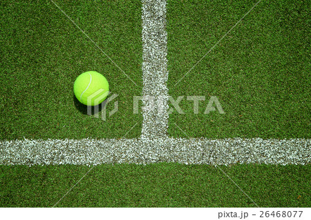 tennis ball near the line on tennis grass court 26468077
