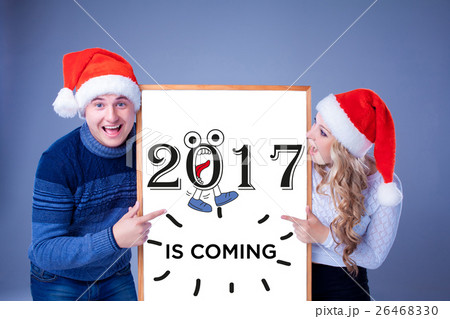 Christmas couple holding white board with empty Christmas couple holding white board with empty 26468330
