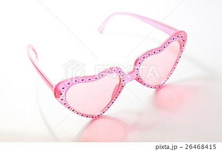 Pink heart shaped sunglasses on white background Pink heart shaped sunglasses on white background 26468415