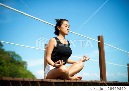 Asian girl meditating at the pier 26469849