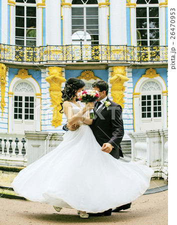 very beautiful bride with groom hugging and very beautiful bride with groom hugging and 26470953