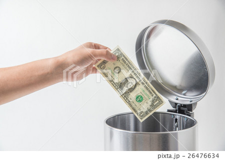 throwing away dollar in trashcan 26476634