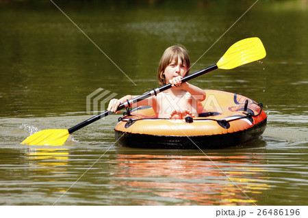 Boy with Blond Hair Paddles Inflatable Rubber Boat 26486196