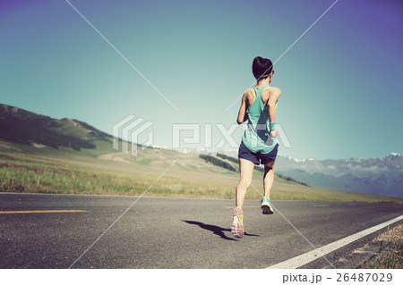 young fitness woman runner running on road young fitness woman runner running on road 26487029