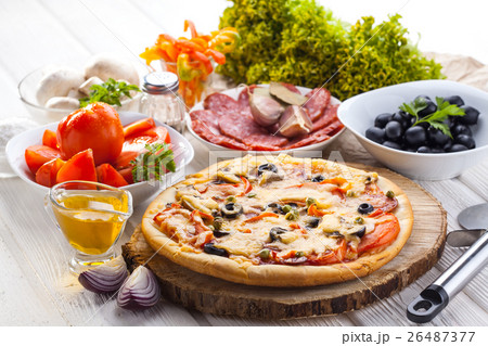 Delicious italian pizza served on wooden table 26487377