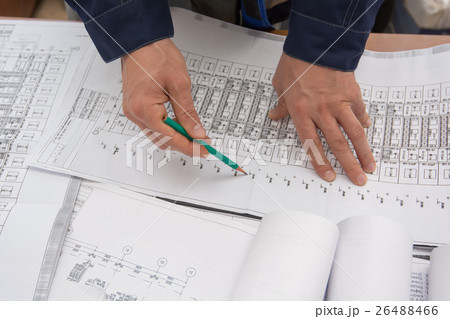 Man holding blueprints at construction site Man holding blueprints at construction site 26488466