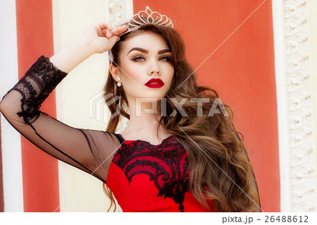 Beautiful young girl in a red evening long dress Beautiful young girl in a red evening long dress 26488612