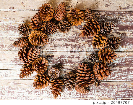 Top view of pine cones on rustic wooden background 26497707