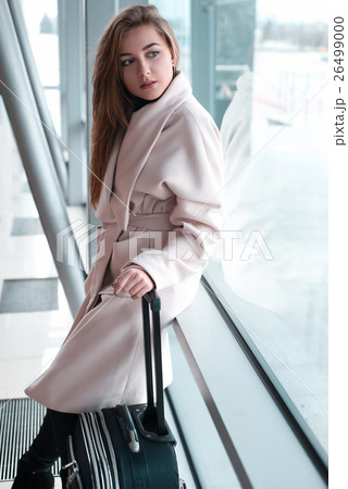 Passenger woman in airport waiting for air travel. Passenger woman in airport waiting for air travel. 26499000