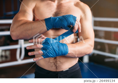 Boxer pulls bandage before the fight or training. 26499134