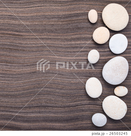 light stones on wooden ebony tree background 26503245
