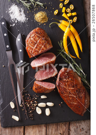 Spicy fried duck fillet close up on a slate board Spicy fried duck fillet close up on a slate board 26507868