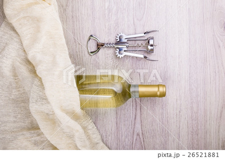 Wine bottle with corkscrew on wooden background Wine bottle with corkscrew on wooden background 26521881