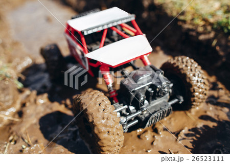 Toy crawler roading on dirty track, close-up Toy crawler roading on dirty track, close-up 26523111