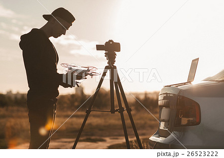 Professional photographer work outdoor at sunset 26523222