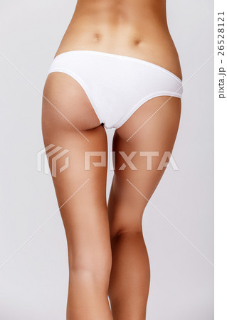 Slim tanned woman's body over gray background 26528121