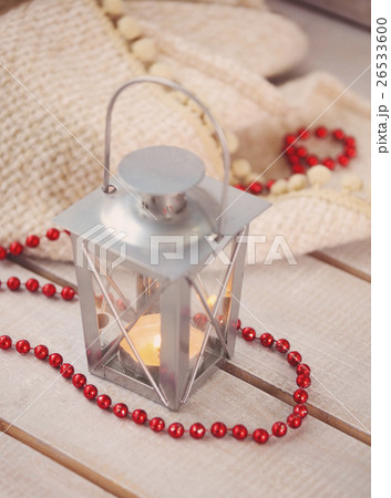 Christmas still life with lantern and red beads Christmas still life with lantern and red beads 26533600