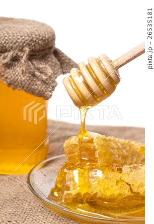 Honey dripping from wooden spoon Honey dripping from wooden spoon 26535181