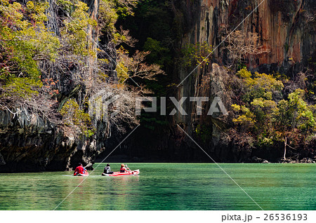 Large limestone rocks surrounded the green lagoon Large limestone rocks surrounded the green lagoon 26536193