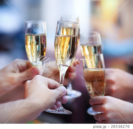 People holding glasses of champagne making a toast 26536270