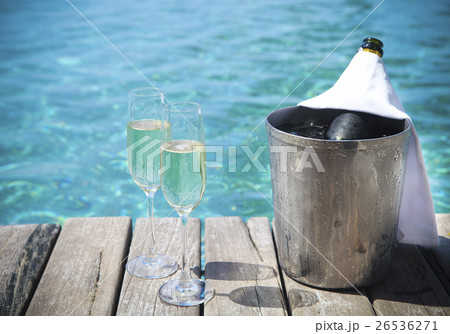 Champagne bottle in ice bucket and glasses 26536271