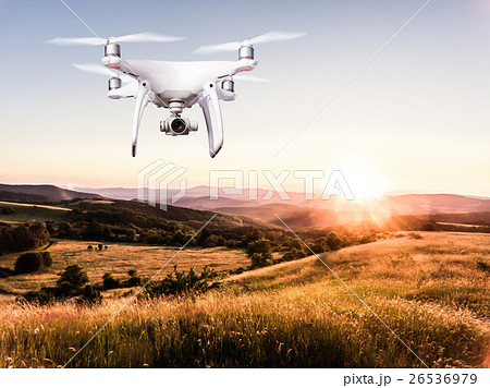 Hovering drone taking pictures of green nature at 26536979