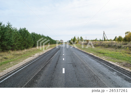 Asphalt highway with white intermittent markings Asphalt highway with white intermittent markings 26537261