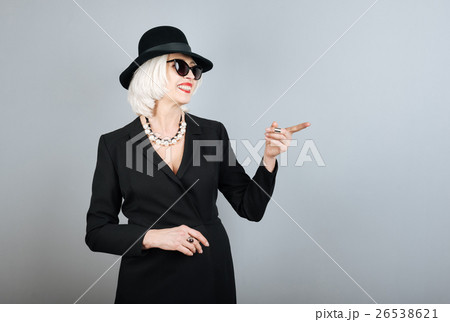 Smiling senior woman pointing on something. Smiling senior woman pointing on something. 26538621