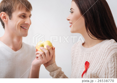 Happy delighted couple holding an apple 26538770