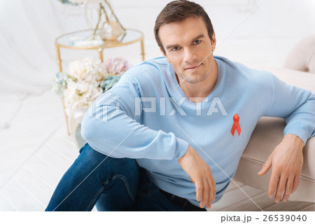 Handsome delighted man leaning on the sofa 26539040